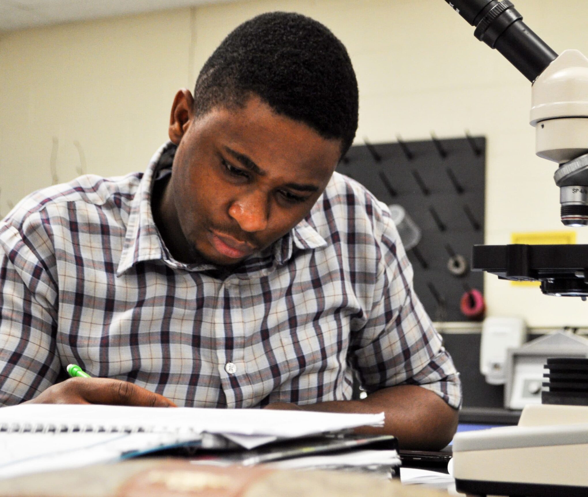 Male Student writing in notebook