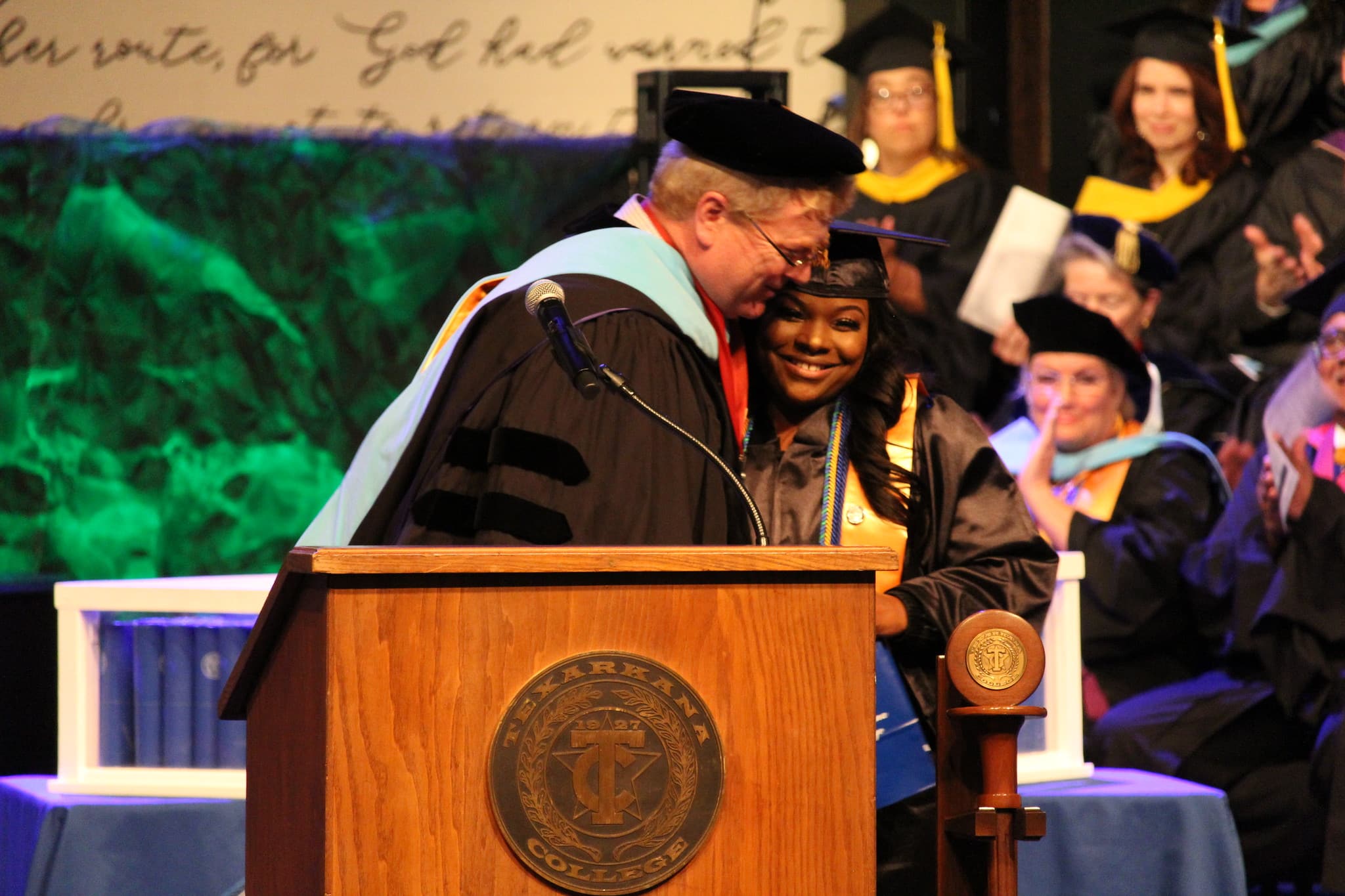 Graduate receives a hug during the commencement ceremony