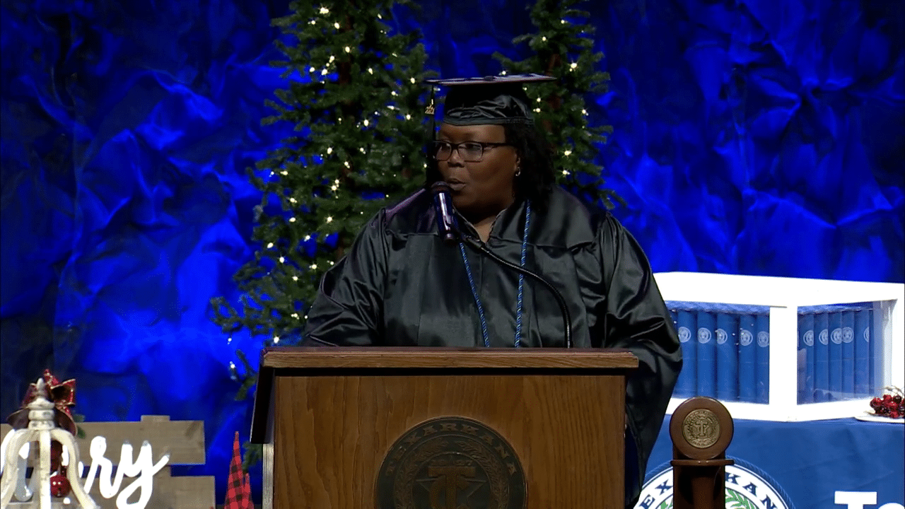 A successful student speaking at graduation who was help by the TRIO Educational Opportunity Center (EOC).