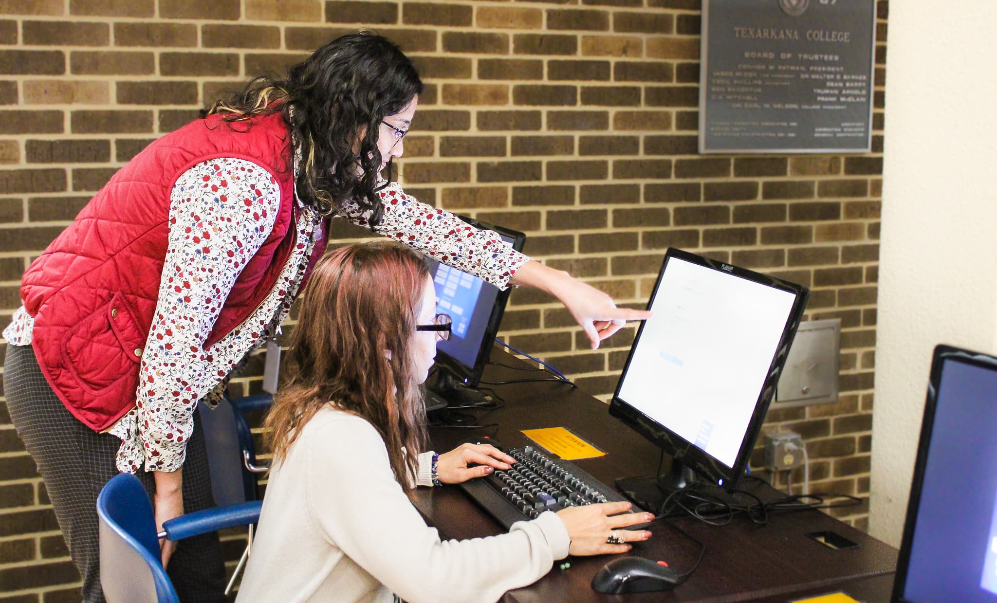 Student completing financial aid application online with assistance from Texarkana College Financial Aid specialist