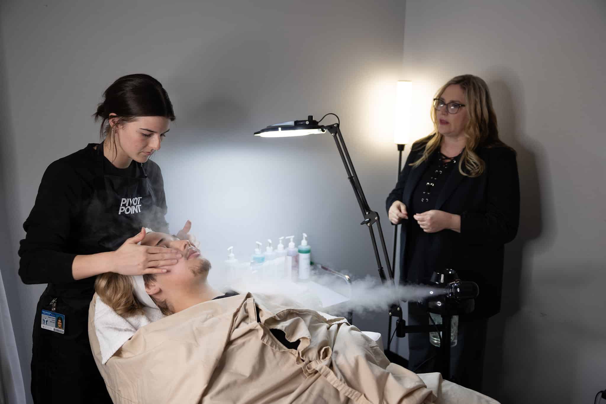 Student providing a facial treatment in class.