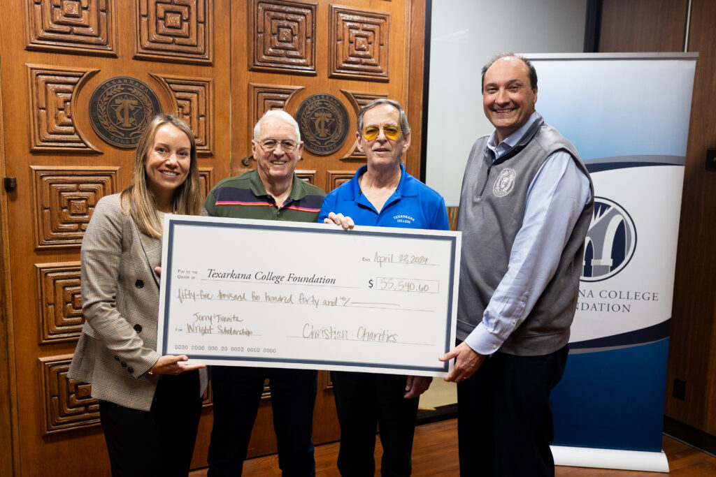 Katie Andrus, TC Foundation Executive Director, Tom Wright, Tim Wright, Dr. Jason Smith, TC President pose for a check presentation