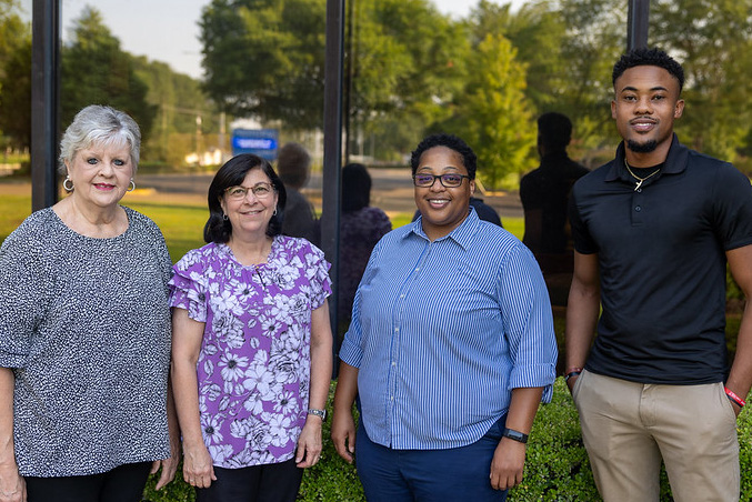 TRIO Talent Search staff pose outside the admin building for a late summer photo