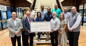 Check presentation in the admin building lobby at the base of the staircase
