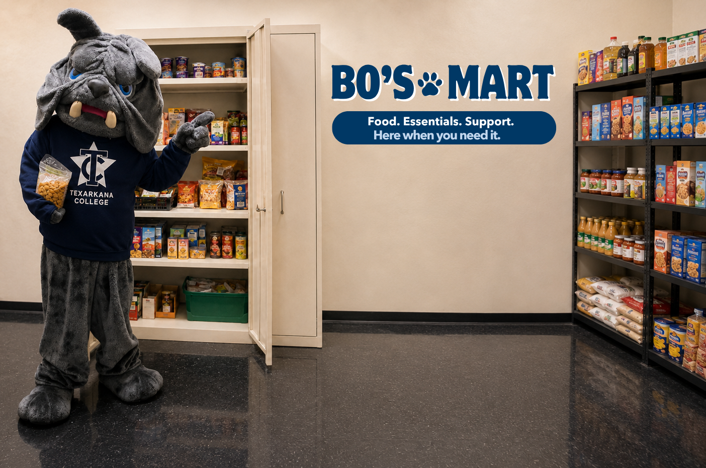 A bulldog mascot in a Texarkana College shirt stands by an open pantry door, surrounded by shelves filled with food items. A sign on the wall reads BOS MART. Food. Essentials. Support. Here when you need it..